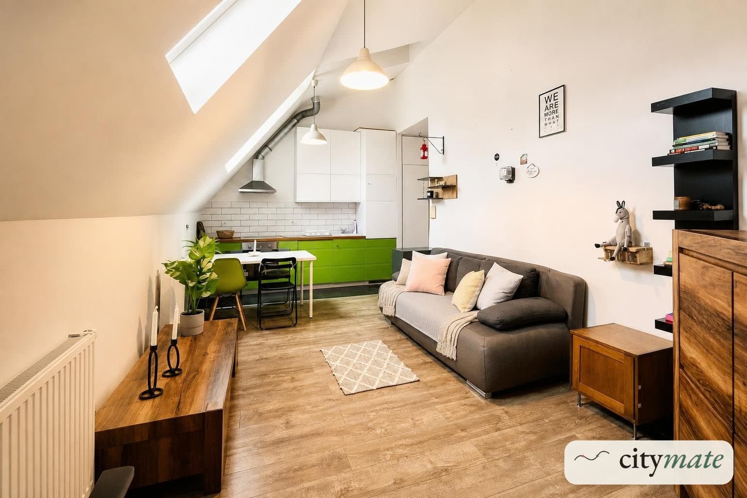 Flat with a desk under a roof window